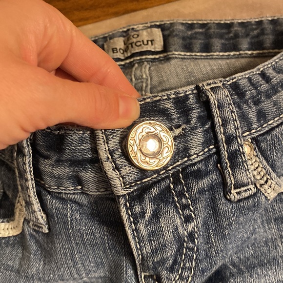 Low cut, boot cut jeans.  Small wear in pocket.  Shown in pictures - Picture 2 of 9